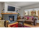 103-707 Spring Creek Drive, Canmore, AB  - Indoor Photo Showing Living Room With Fireplace 