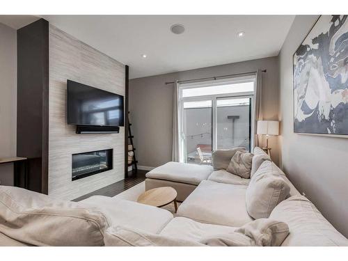 2-2426 24A Street Sw, Calgary, AB - Indoor Photo Showing Living Room With Fireplace