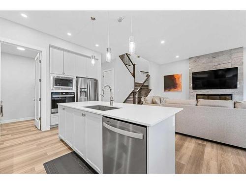 322 Edith Road Nw, Calgary, AB - Indoor Photo Showing Kitchen With Fireplace With Stainless Steel Kitchen With Upgraded Kitchen