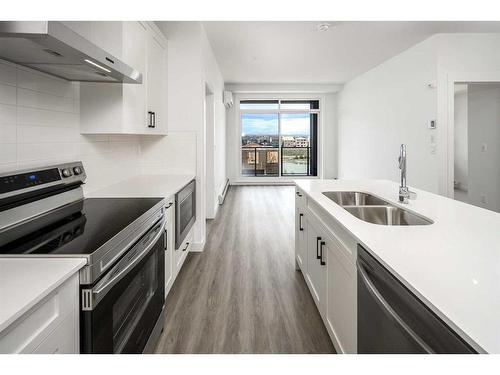 1305-55 Lucas Way Nw, Calgary, AB - Indoor Photo Showing Kitchen With Stainless Steel Kitchen With Double Sink With Upgraded Kitchen