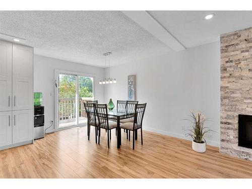 815 Sabrina Road Sw, Calgary, AB - Indoor Photo Showing Dining Room With Fireplace