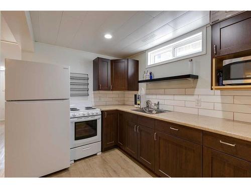 23 & 25 Creston Crescent Nw, Calgary, AB - Indoor Photo Showing Kitchen With Double Sink