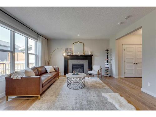 202 Auburn Sound Manor Se, Calgary, AB - Indoor Photo Showing Living Room With Fireplace