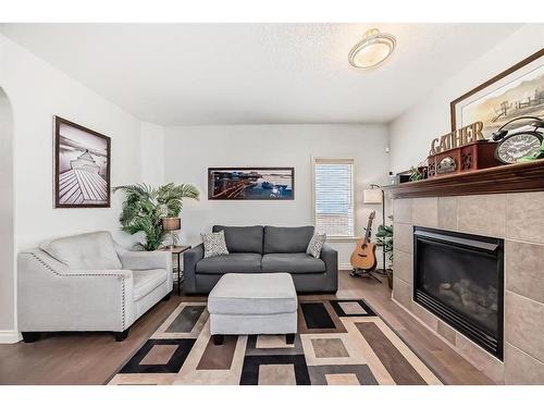 607 Hamptons Place Se, High River, AB - Indoor Photo Showing Living Room With Fireplace