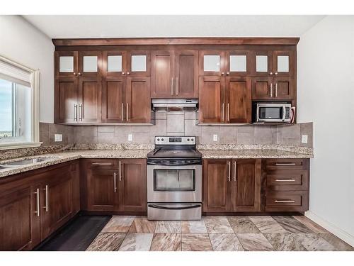 607 Hamptons Place Se, High River, AB - Indoor Photo Showing Kitchen With Double Sink