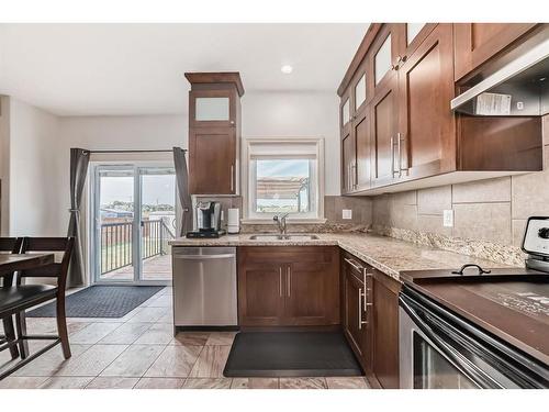 607 Hamptons Place Se, High River, AB - Indoor Photo Showing Kitchen With Double Sink