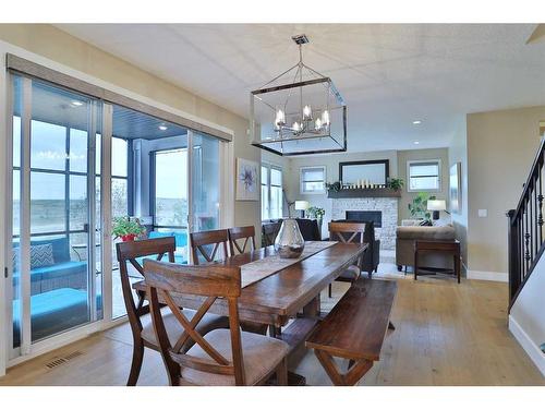 39 Prairie Smoke Rise, Rural Rocky View County, AB - Indoor Photo Showing Dining Room With Fireplace