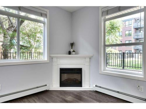 101-323 18 Avenue Sw, Calgary, AB - Indoor Photo Showing Living Room With Fireplace