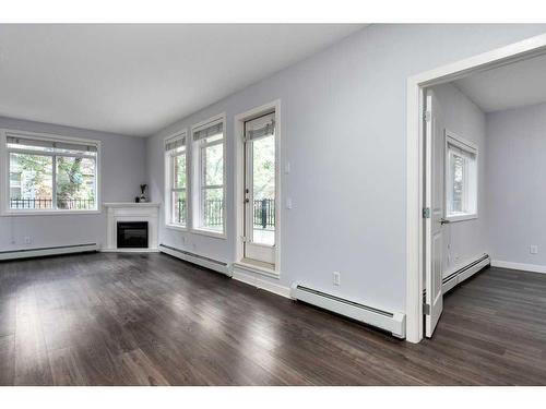 101-323 18 Avenue Sw, Calgary, AB - Indoor Photo Showing Living Room With Fireplace