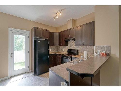 221 Ranch Ridge Meadow, Strathmore, AB - Indoor Photo Showing Kitchen With Double Sink