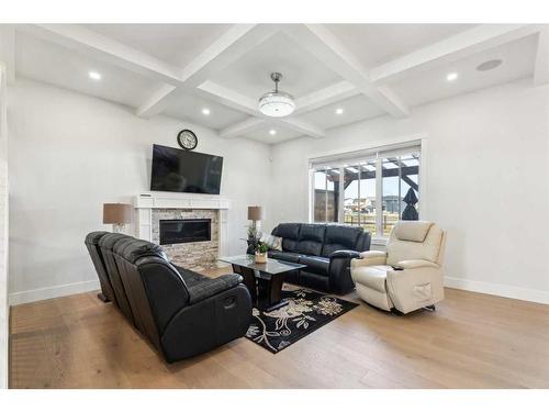 1476 Coopers Landing Sw, Airdrie, AB - Indoor Photo Showing Living Room With Fireplace