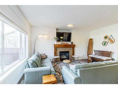 143 New Brighton Close Se, Calgary, AB - Indoor Photo Showing Living Room With Fireplace