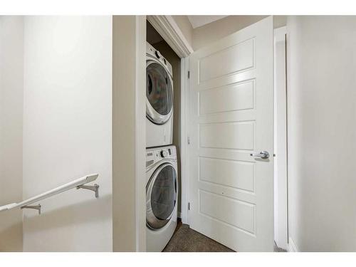 517-2400 Ravenswood View Se, Airdrie, AB - Indoor Photo Showing Laundry Room