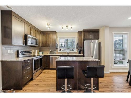 517-2400 Ravenswood View Se, Airdrie, AB - Indoor Photo Showing Kitchen With Stainless Steel Kitchen With Upgraded Kitchen