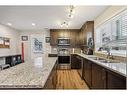 517-2400 Ravenswood View Se, Airdrie, AB  - Indoor Photo Showing Kitchen With Stainless Steel Kitchen With Double Sink With Upgraded Kitchen 