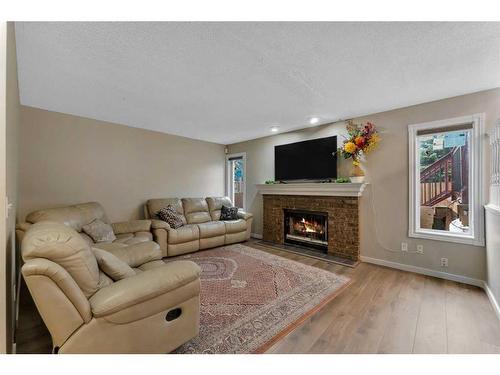 97 Shawinigan Drive Sw, Calgary, AB - Indoor Photo Showing Living Room With Fireplace