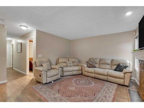 97 Shawinigan Drive Sw, Calgary, AB - Indoor Photo Showing Living Room With Fireplace