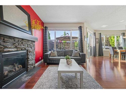 393 River Heights Drive, Cochrane, AB - Indoor Photo Showing Living Room With Fireplace