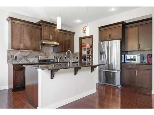 393 River Heights Drive, Cochrane, AB - Indoor Photo Showing Kitchen With Stainless Steel Kitchen With Upgraded Kitchen