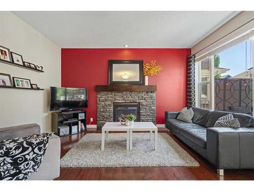 393 River Heights Drive, Cochrane, AB - Indoor Photo Showing Living Room With Fireplace