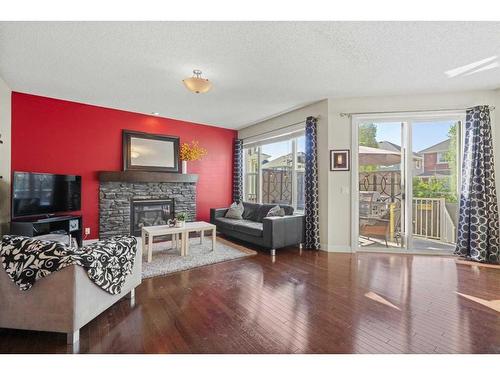 393 River Heights Drive, Cochrane, AB - Indoor Photo Showing Living Room With Fireplace