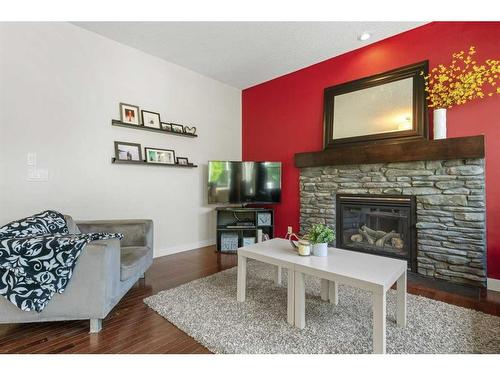 393 River Heights Drive, Cochrane, AB - Indoor Photo Showing Living Room With Fireplace