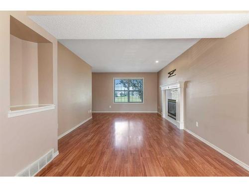 714 Martindale Boulevard Ne, Calgary, AB - Indoor Photo Showing Other Room With Fireplace