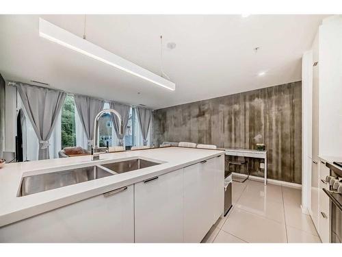 208-1020 9 Avenue Se, Calgary, AB - Indoor Photo Showing Kitchen With Double Sink