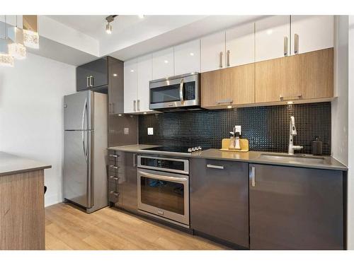 314-619 Confluence Way Se, Calgary, AB - Indoor Photo Showing Kitchen With Stainless Steel Kitchen With Upgraded Kitchen