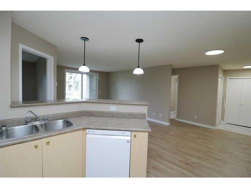 8119-304 Mackenzie Way Sw, Airdrie, AB - Indoor Photo Showing Kitchen With Double Sink