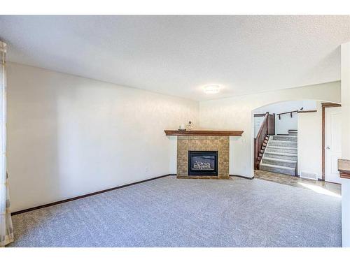 48 Eversyde Manor Sw, Calgary, AB - Indoor Photo Showing Living Room With Fireplace