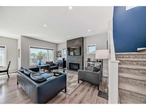 572 Chinook Gate Square Sw, Airdrie, AB - Indoor Photo Showing Living Room With Fireplace