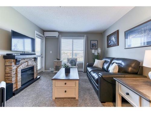 2332-81 Legacy Boulevard Se, Calgary, AB - Indoor Photo Showing Living Room With Fireplace