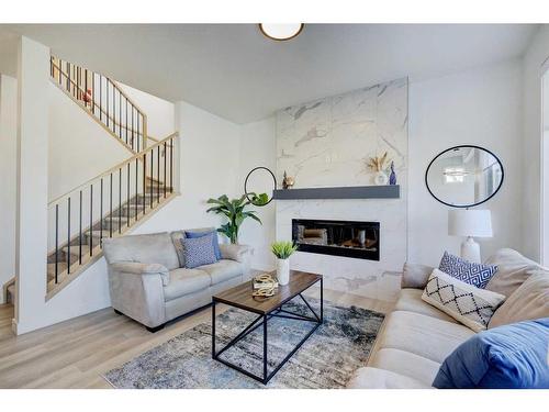 3 Lawrence Green Se, Airdrie, AB - Indoor Photo Showing Living Room With Fireplace