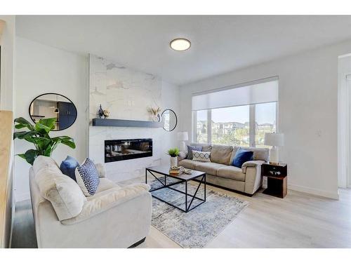 3 Lawrence Green Se, Airdrie, AB - Indoor Photo Showing Living Room With Fireplace