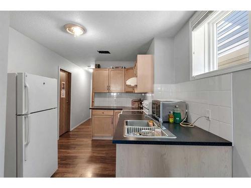 163 Taravista Drive Ne, Calgary, AB - Indoor Photo Showing Kitchen With Double Sink