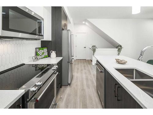 130-2117 81 Street, Calgary, AB - Indoor Photo Showing Kitchen With Double Sink