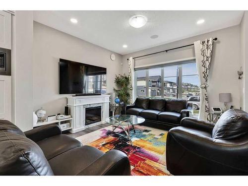 851 Carrington Boulevard Nw, Calgary, AB - Indoor Photo Showing Living Room With Fireplace