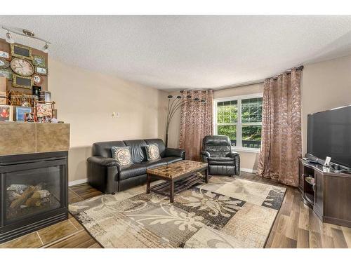 267 Silverado Drive Sw, Calgary, AB - Indoor Photo Showing Living Room With Fireplace