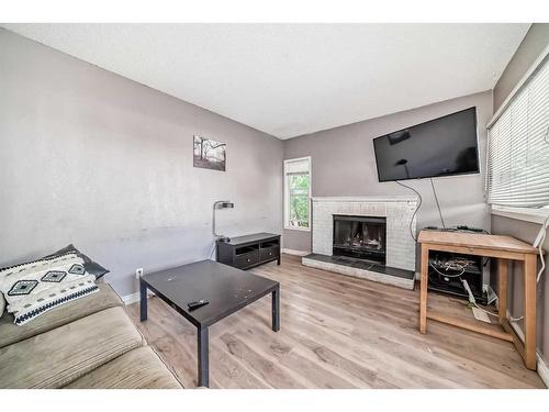 31 Shawcliffe Place Sw, Calgary, AB - Indoor Photo Showing Living Room With Fireplace