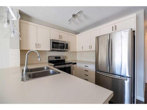 202-130 Auburn Meadows View Se, Calgary, AB - Indoor Photo Showing Kitchen With Stainless Steel Kitchen With Double Sink With Upgraded Kitchen