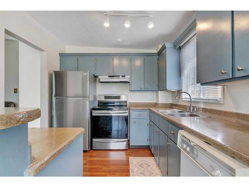 110 Hunterbrook Place Nw, Calgary, AB - Indoor Photo Showing Kitchen With Double Sink