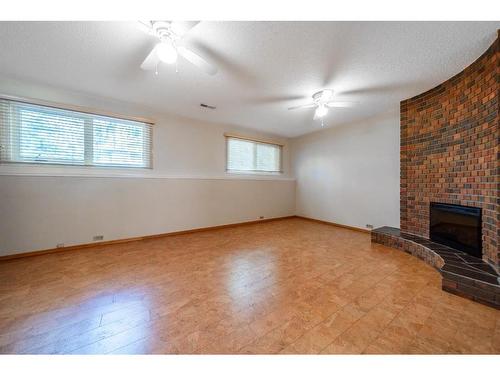 5251 Barron Drive Nw, Calgary, AB - Indoor Photo Showing Other Room With Fireplace