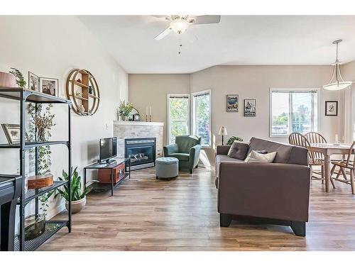 201-16 Poplar Avenue, Okotoks, AB - Indoor Photo Showing Living Room With Fireplace