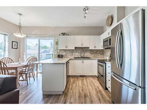 201-16 Poplar Avenue, Okotoks, AB - Indoor Photo Showing Kitchen With Upgraded Kitchen