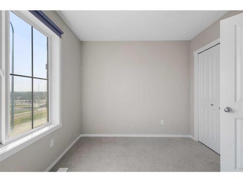 1412-125 Panatella Way Nw, Calgary, AB - Indoor Photo Showing Other Room