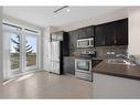 1412-125 Panatella Way Nw, Calgary, AB  - Indoor Photo Showing Kitchen With Stainless Steel Kitchen With Double Sink 