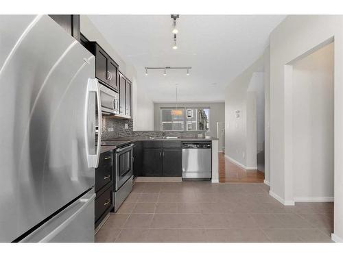 1412-125 Panatella Way Nw, Calgary, AB - Indoor Photo Showing Kitchen With Stainless Steel Kitchen With Upgraded Kitchen