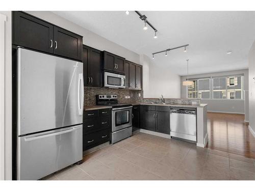 1412-125 Panatella Way Nw, Calgary, AB - Indoor Photo Showing Kitchen With Stainless Steel Kitchen With Upgraded Kitchen