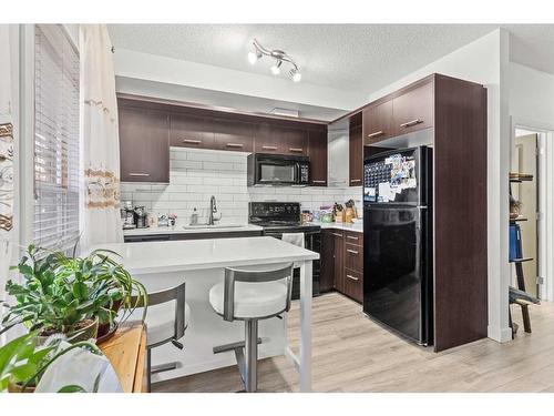 104-323 18 Avenue Sw, Calgary, AB - Indoor Photo Showing Kitchen With Upgraded Kitchen